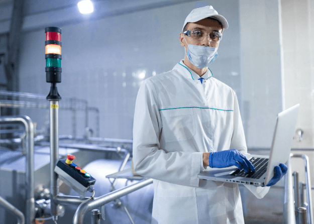 technologist-white-coat-with-laptop-his-hands-controls-production-process-dairy-shop-place-writing-technologist-with-laptop-computer-is-factory